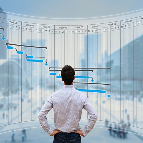 Man looking at graphs on large virtual screen