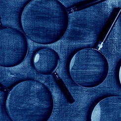 Magnifying glasses on blue background